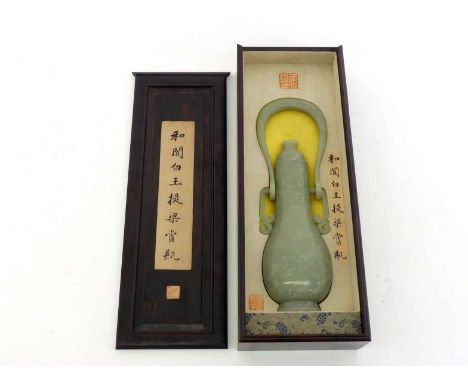 A large Chinese carved celadon jade hanging vase in hardwood box, body decorated with archaic style mask patterns, tall swing