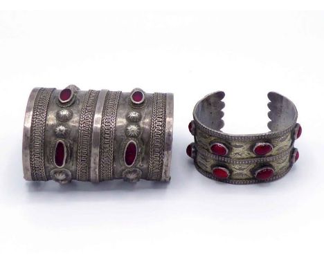 A North African white metal and red paste cuff bangle, with two-band construction, applied with bosses and wire work, 8.8cm l