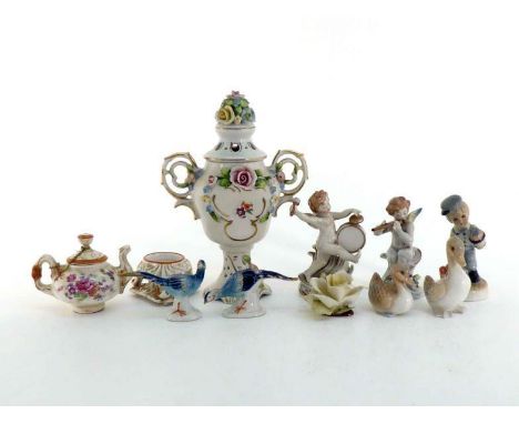 Ten ceramic pieces comprising two Capodimonte cherubs, one playing a flute, the other a drum and cymbals; a messenger boy car