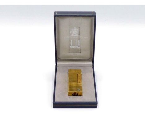 Dunhill, a gilt metal lighter, in a fitted Dunhill box CONDITION: screw missing to filling aperture, otherwise good