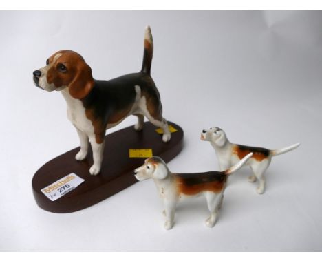 Beswick Connoisseur model beagle on wooden stand and two Beswick hounds 