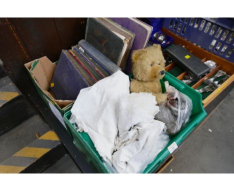 Two boxes of cigarette card collections, christening gowns, vintage Teddy bear, doll parts etc 