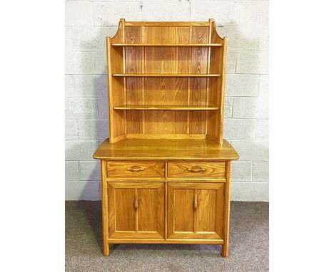 An Ercol ash dresser, with gallery back and two drawers and two cabinet doors, 183cm high, 107cm wide