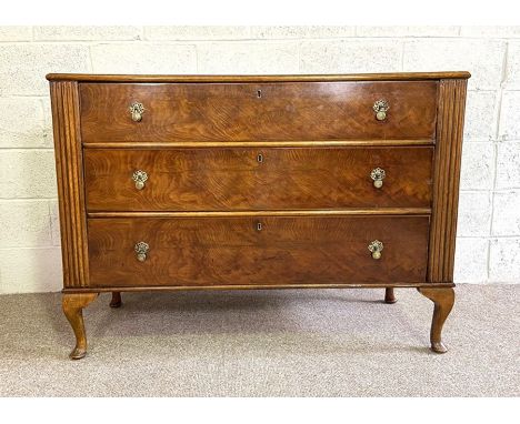 An Art Deco oak and walnut veneered bedroom commode or chest, with three long drawers and squat cabriole legs