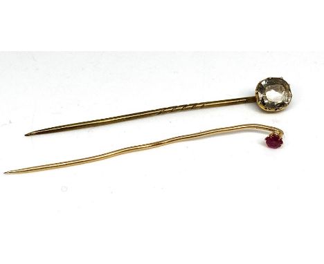 A ruby and gold stick pin, marks indistinct, with another stick pin (2)