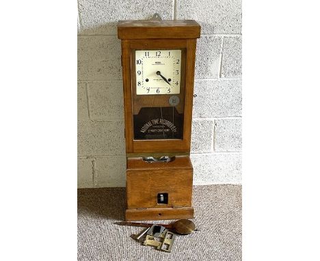 A National Time Recorder 'clocking in' machine, with a square dial, signed National, with a stepped oak case and ticket stamp