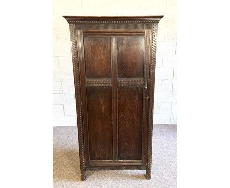A vintage oak single wardrobe with guilloche carved border