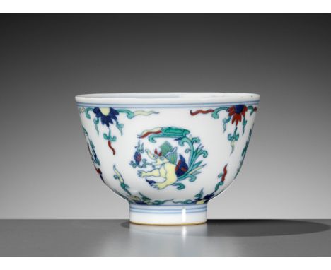 A DOUCAI 'MAKARA' CUP, KANGXI TO YONGZHENG PERIODChina, c. 1680-1730. Elegantly potted, the rounded sides rising from a tall,