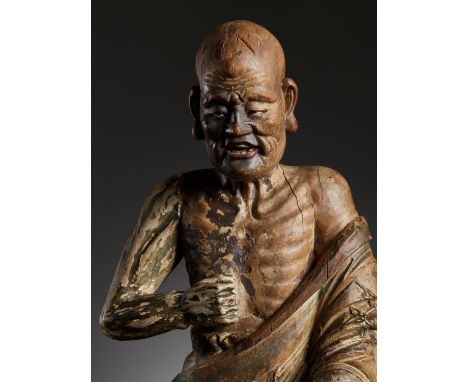 A PAINTED WOOD AND GESSO FIGURE OF A LUOHAN, MING DYNASTYChina, 1368-1644. Powerfully carved, seated in a calm posture atop a