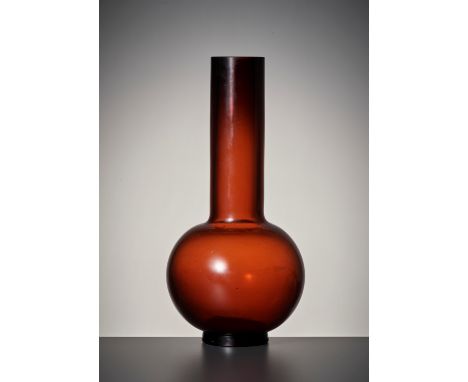 A TRANSLUCENT AMBER GLASS BOTTLE VASE, QING DYNASTYChina, 18th-19th century. The globular body supported on a thick, slightly