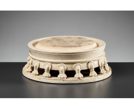 A RARE WHITE-GLAZED CIRCULAR INKSTONE, TANG DYNASTYChina, 618-907. The central unglazed grinding surface is encircled by a na