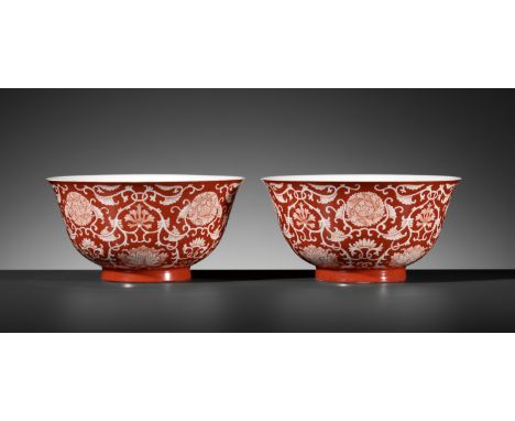 A PAIR OF REVERSE-DECORATED CORAL-GROUND 'PEONY AND LOTUS' BOWLS, QIANLONG SEAL MARKS AND OF THE PERIODChina, 1736-1795. Each