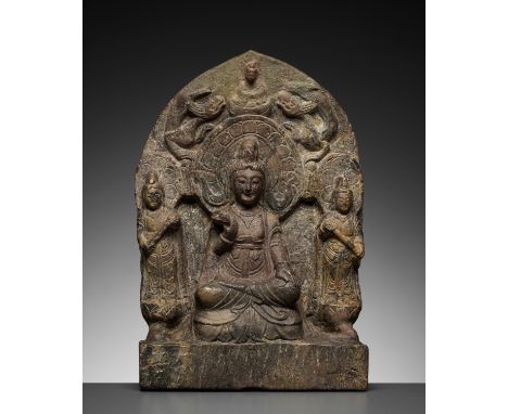 A LIMESTONE BUDDHIST TRIAD STELE OF GUANYIN, NORTHERN WEI TO TANG DYNASTYChina, 386-907. The stele of ogee arch form. Finely 