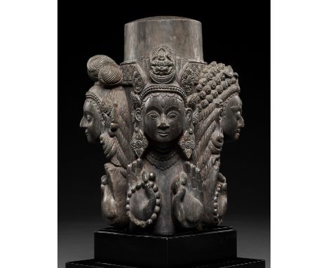 A CARVED STONE LINGA, NEPAL, 16TH-17TH CENTURYSuperbly carved with four faces each representing aspects of Shiva, all four ho