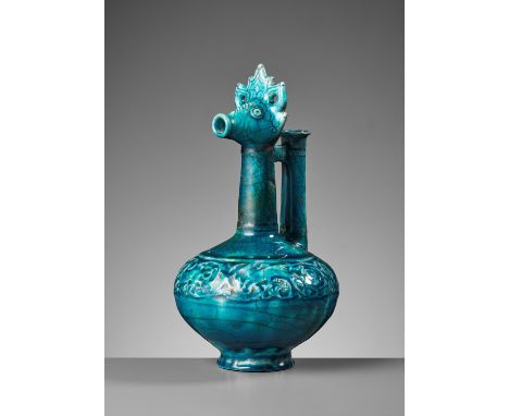 A KASHAN TURQUOISE-GLAZED ZOOMORPHIC POTTERY EWERPersia, 12th-13th century. The compressed globular body rising from a short 