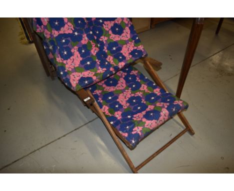 A vintage deck chair, having sun canopy