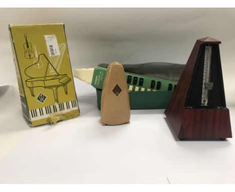 Three metronomes one harmonica and a mandolin.