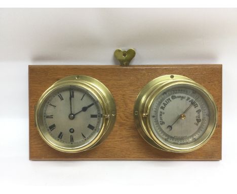 A wall mounted brass clock and barometer set. Shipping category D.