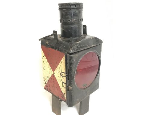 A 19th century red and white signaling lamp on four feet. This lot cannot be posted