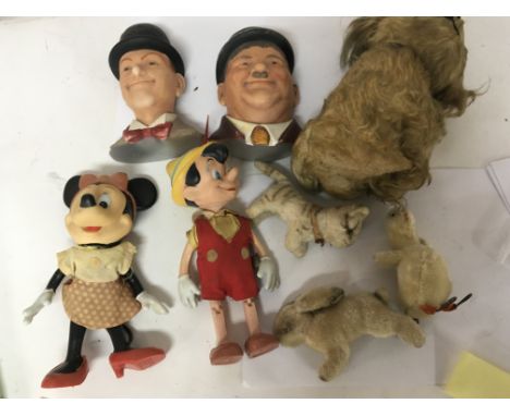A collection of Vintage small Steiff animals a Vintage Pinocchio and Mini Mouse a Vintage dog and Plaster Laurel and Hardy wa