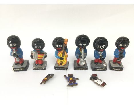 A collection of Robertson's golly band figures and three conforming enamel badges. Shipping category B.