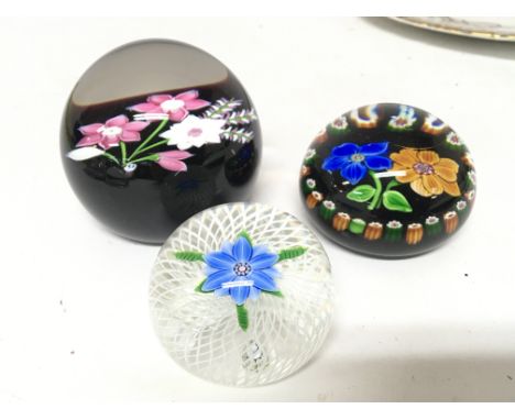 A Caithness limited edition paperweight 2/50 and two other paper weights with floral pattern and opaque glass intwined canes 
