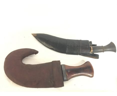 A 19th century Omani dagger with possibly horn handle (33cm long) and a vintage Nepalese Kukrl with sharpener and skinning kn