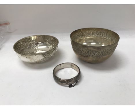 Two silver bowls and one silver bangle.