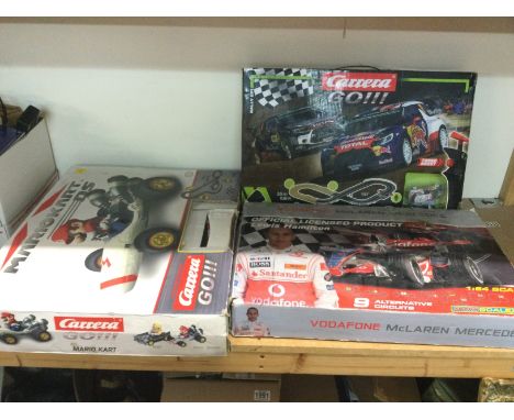 Three boxed racing sets comprising a Carrera Go Rally Up, Mariokart DS Carrera Go and a Microscalextric Vodafone McLaren Merc