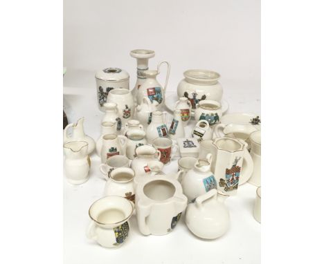 A collection of WH Goss crested china including large candle stick hair tidy jugs and smaller created ware no obvious damage.