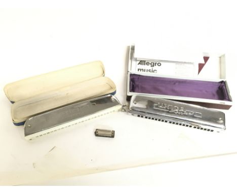 Two boxed harmonicas including a Unica Formal & a Meridian Stage pro. Also including a Hohner Little Lady. Postage category B