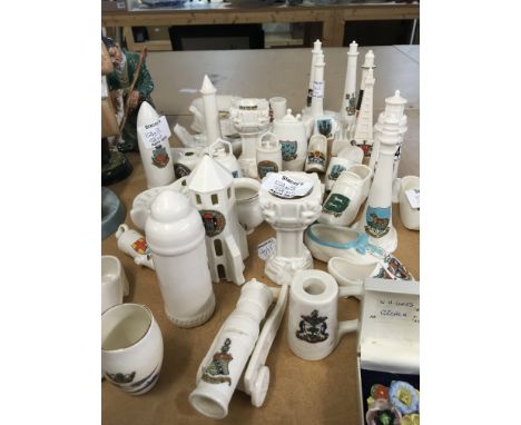 A collection of WH Goss crested china including light houses military tanks and shells fonts shoes and many others no obvious