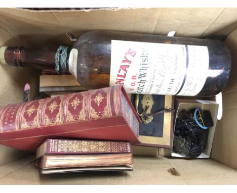 A collection of assorted items including belt buckles, British Ballads book, large empty Mackinkays Scotch Whiskey bottle etc