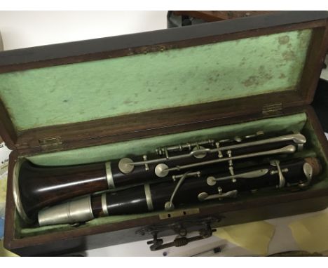 A cased banjo ukulele in a fitted case a cased trumpet and a clarinet (3)