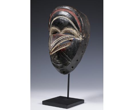 Liberia, Dan Mio, face mask, with a promenant bird's beak. Provenance Martien Coppens, Eindhoven. A a black and white photo p