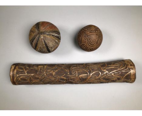 P.N. Guinea, two coconut shell music instruments, carved and one with pigments. Herewith an Asmat bamboo horn, fu. Provenance