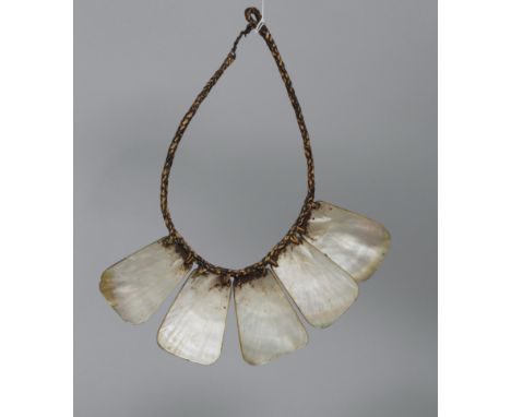 Philippines, Ifugao, palangapang mother-of-pearl chest ornament. The five plaques connected to the braited rattan support. Wo
