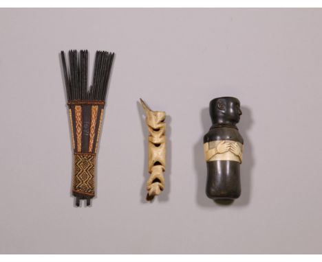 Solomon Islands, wooden comb and Asmat, bone nose ornament. Herewith a horn container in the shape of a figure. [3]  