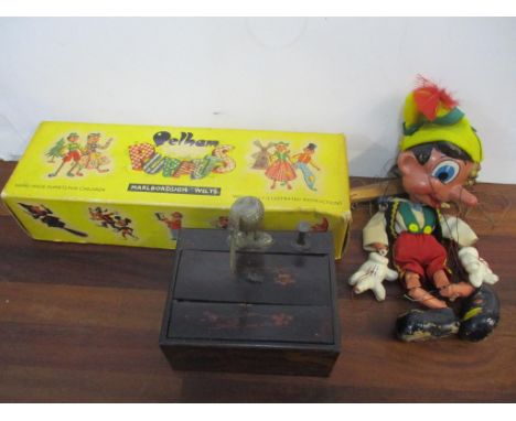 A Pelham puppet Pinocchio boxed, and a Japanese lacquered cigarette box with an articulated bird 
