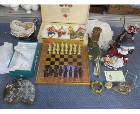 A boxed set of four glass Christmas tree ornaments in the form of clowns, a small teddy bear in a doll's house pram, a Knight
