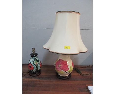 A Moorcroft poppy pattern table lamp of inverted baluster form, mounted on a wood effect base, height 22cm (without fittings)