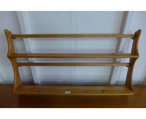 An Ercol pine wall hanging plate rack 