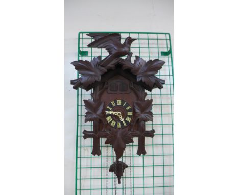 A Black Forest carved wood cuckoo clock 
