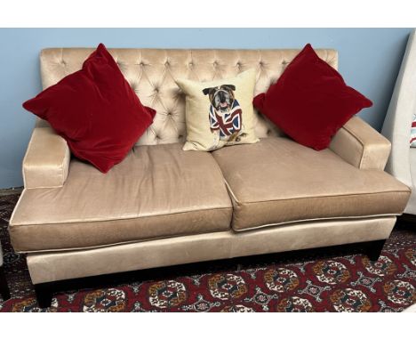 A modern two seater upholstered settee with button back upholstery on square tapering legs 