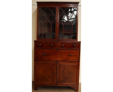 A George III mahogany secretaire bookcase, the moulded cornice above a pair of arched glazed doors, the base with a rectangul