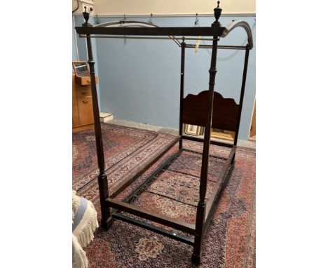 A Heal's of Tottenham Court Road mahogany four poster single bed, with an arched top, with leaf cappings and a tapering colum