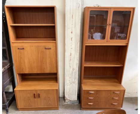 A G-Plan teak wall unit with central drinks cabinet, shelves and cupboard base together with a matching unit with glazed door