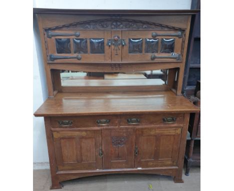A 20th century oak mirror back sideboard, the raised back with a pair of glazed doors, the base with two drawers and two cupb