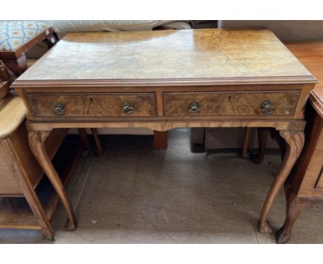 A walnut side table, the rectangular top above two drawers and cabriole legs with pointed pad feet