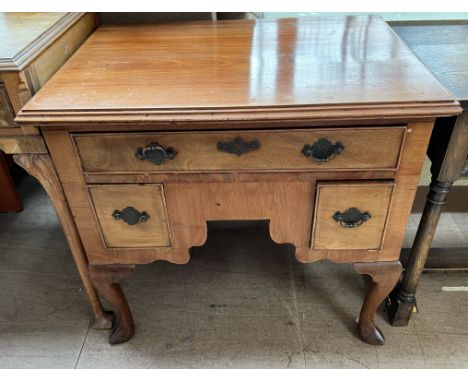 A mahogany lowboy with a rectangular top above an arrangement of three drawers on cabriole legs and pointed pad feet